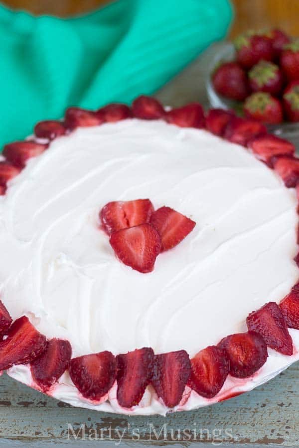 A slice of cake on a plate, with Strawberry