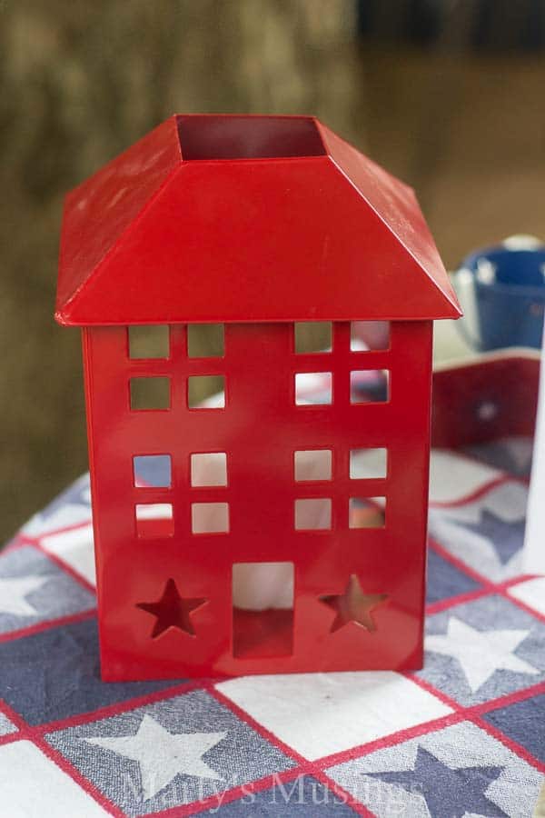 Red decorative candle holder on red white and blue star tablecloth