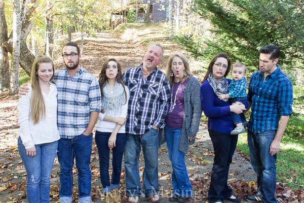 A group of people standing next to a tree