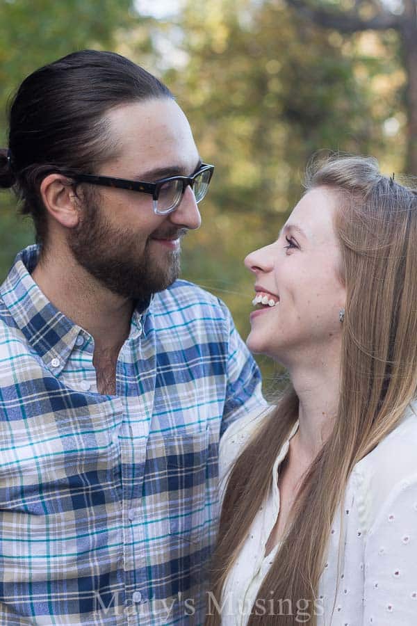 A man and a woman in glasses looking at the camera