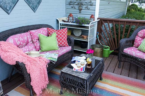 Colorful front deck with dark furniture and flowers