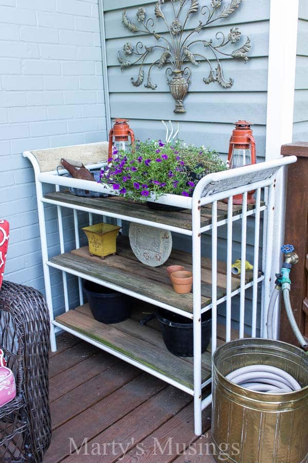 Potting table with colorful flowers and accessories on front deck