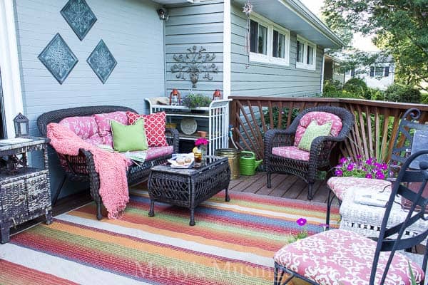 Front deck filled with colorful furniture and flowers