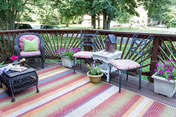 Striped rug and flowers on front deck