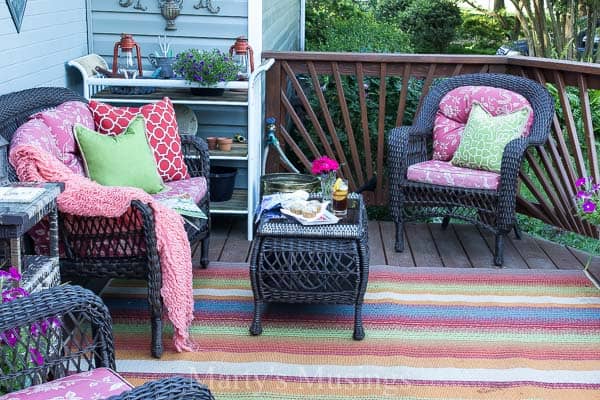 Front deck filled with colorful cushions and patterned rug