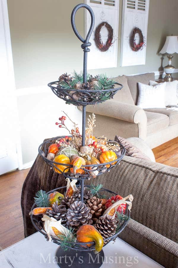 A bowl of fruit sitting on top of a wooden table, with Idea and Home