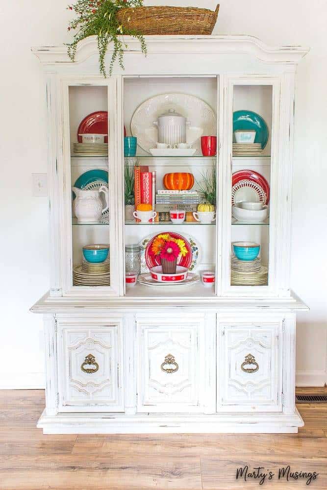 White china hutch decorated with orange and blue for fall