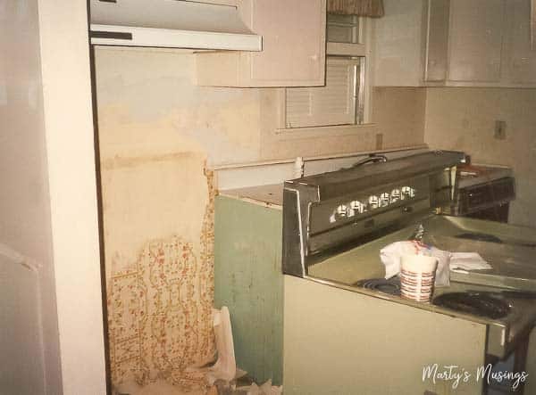 A kitchen with a sink and a refrigerator