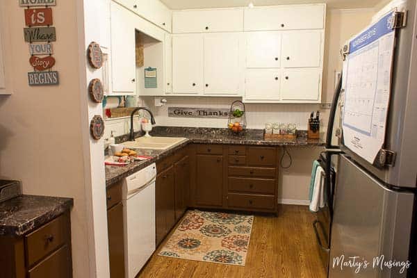 A kitchen with a sink and a refrigerator