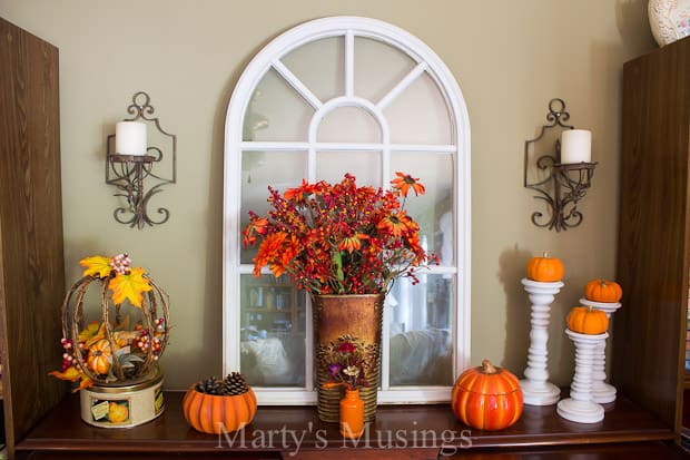 Inexpensive fall vignette with shutters and yard sale treasures decorate a pretend mantel!