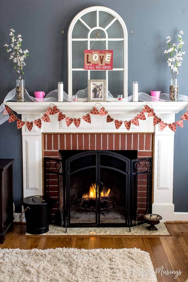 Banner made from heart paper bags and hung over fireplace