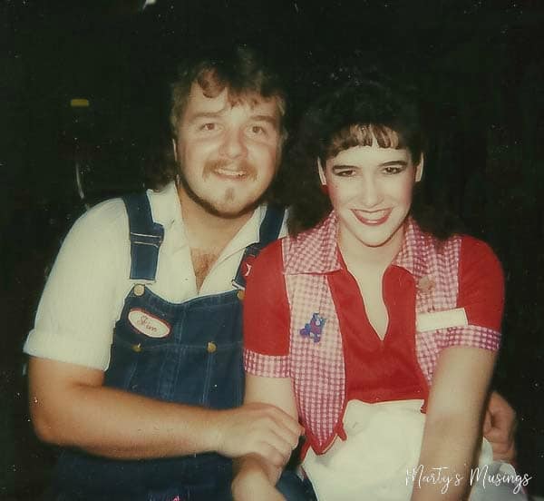 A man and a woman posing for a photo, with Gift Bag