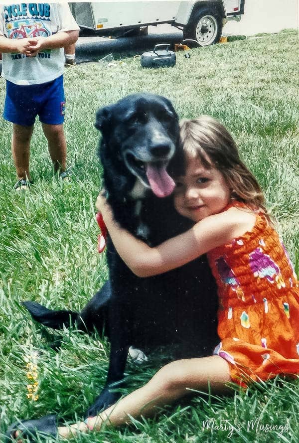 A little girl holding a dog