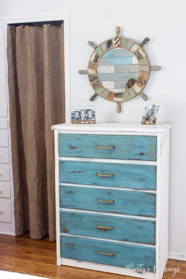 Blue chalk painted dresser with ship's wheel mirror