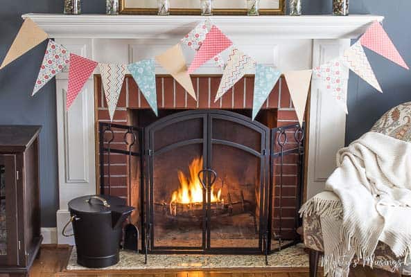 A fire place sitting in a chair next to a fireplace