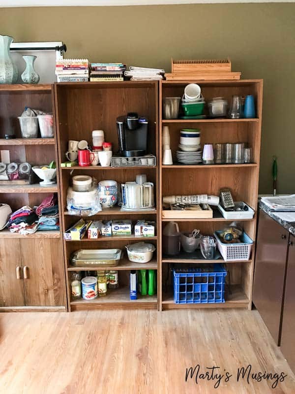 Bookshelves holding kitchen supplies for remodel