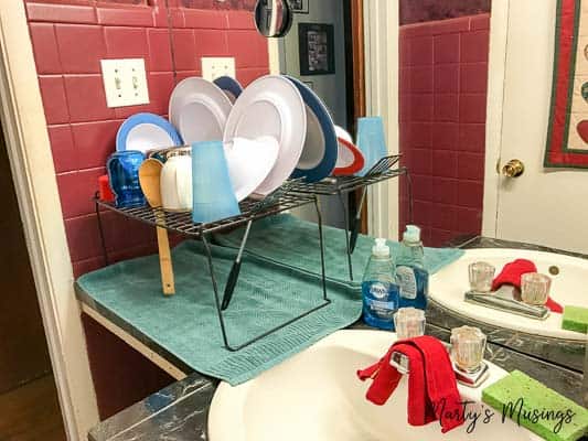 A bathroom with a sink and temp kitchen storage