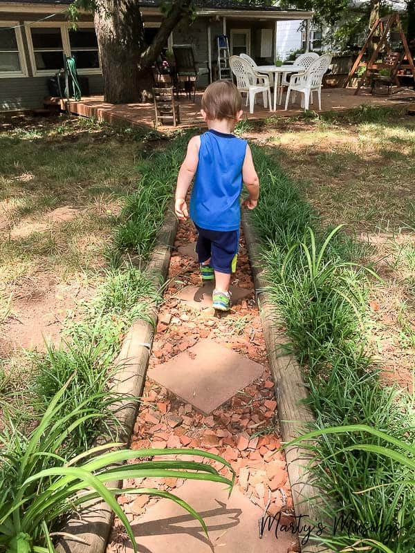 A little boy that is standing in the grass