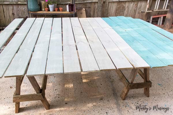 An empty bench sitting on top of a wooden table