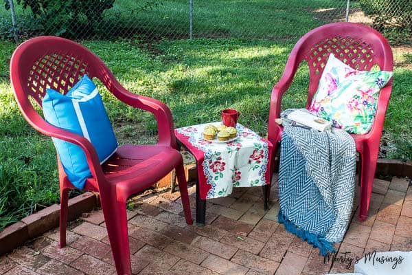 Two red chairs for entertaining with pillows and snacks