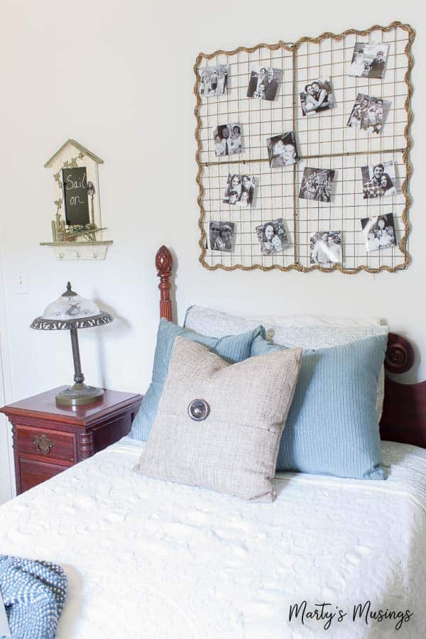 Metal wall hanging with pictures and vintage twin bed