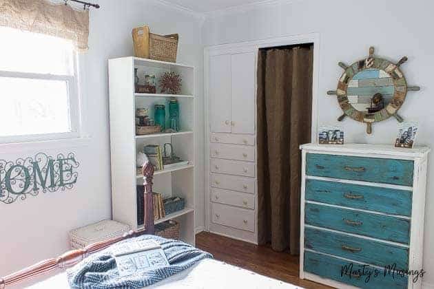 coastal themed bedroom with aqua and white furnishings