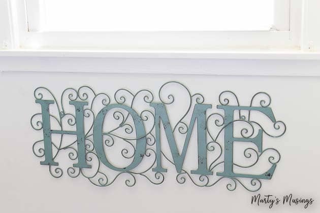 Aqua metal sign with home on it
