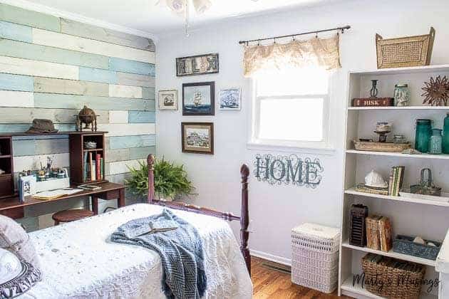 Coastal bedroom with plank wall and blue and white accessories