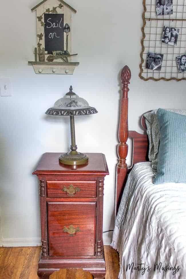 A vintage lamp beside a vintage twin bed