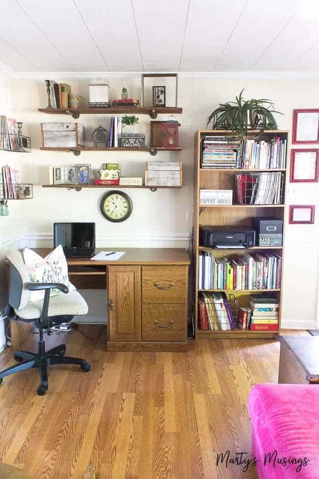 A living room filled with furniture and a book shelf