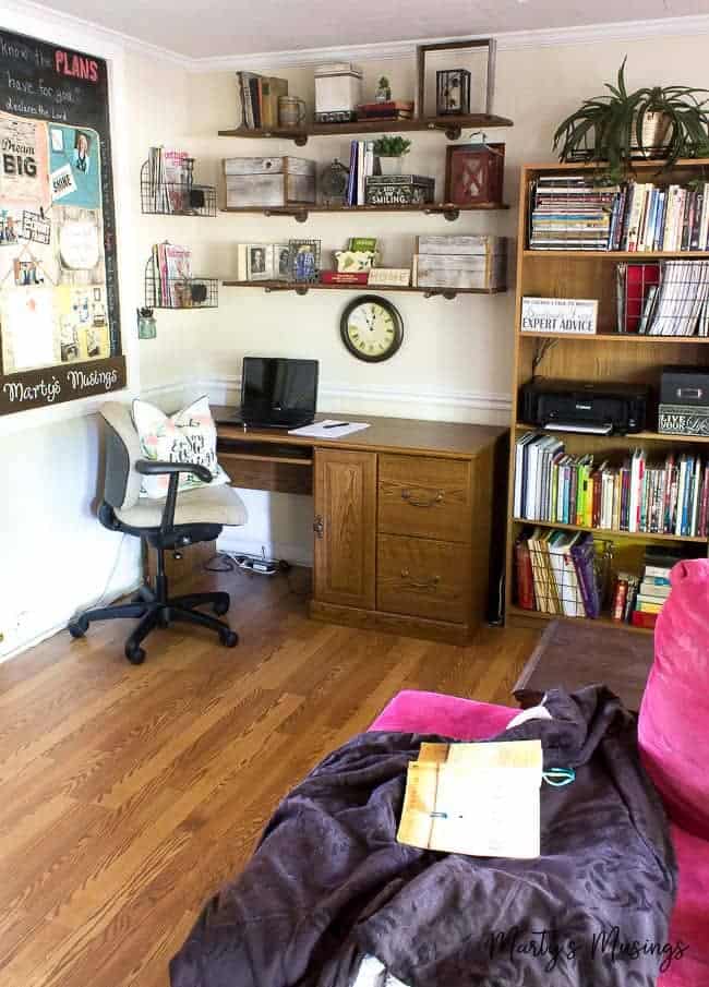 A living room filled with furniture and a book shelf