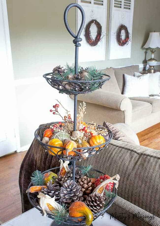 A living room filled with furniture and vase of flowers on a table