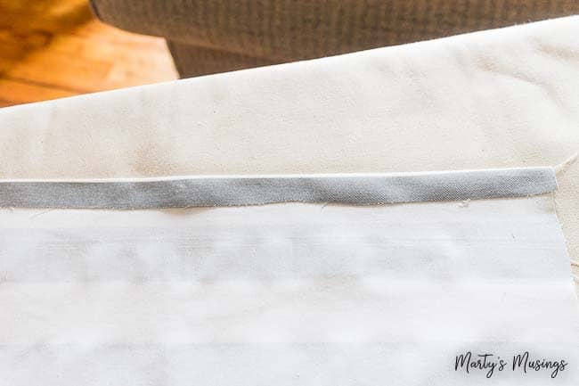 Don't know how to sew but still want a beautiful, inexpensive bedroom? Learn how to pull it all together with this easy no sew DIY bed skirt tutorial, pictures included!