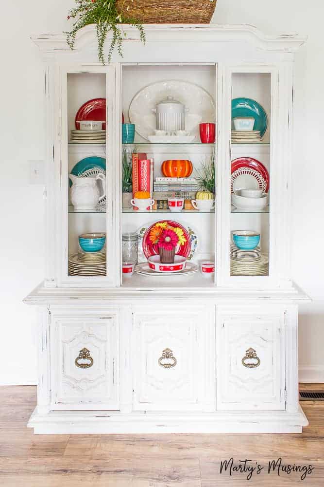 White china hutch with red and blue accents