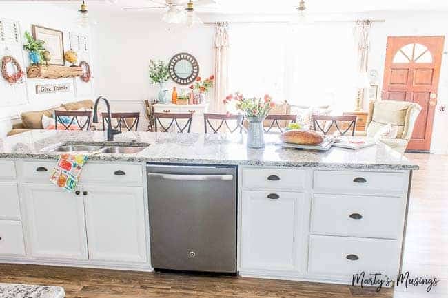 Large kitchen island with dishwasher and sink open to family room