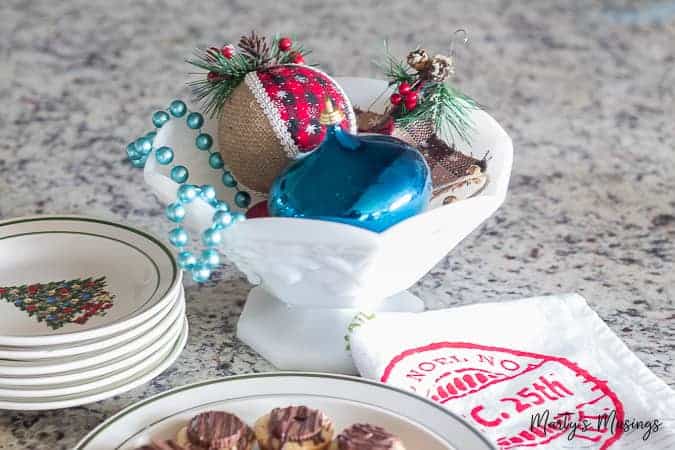 This rustic Christmas kitchen decor is simple to pull together using aqua and red accents for a pop of color and easy, thrifted accessories!