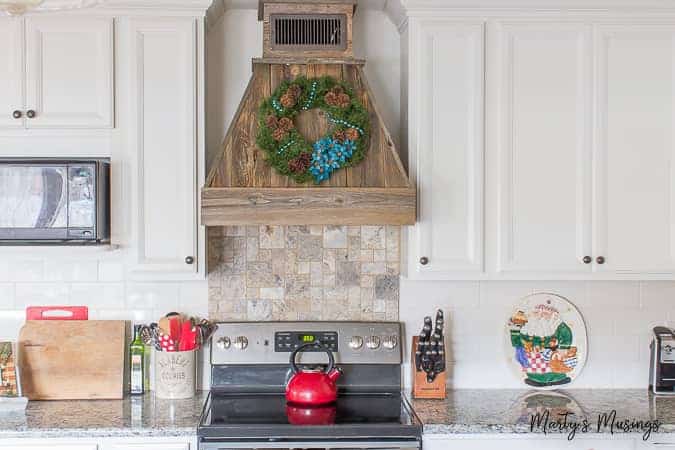 A kitchen with a stove top oven sitting next to a fireplace