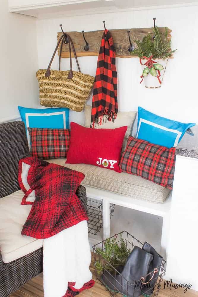 red and black buffalo plaid pillows and scarf on a bench