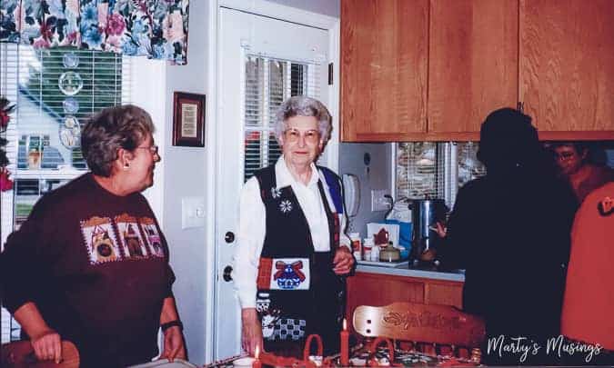 A group of people standing in a kitchen