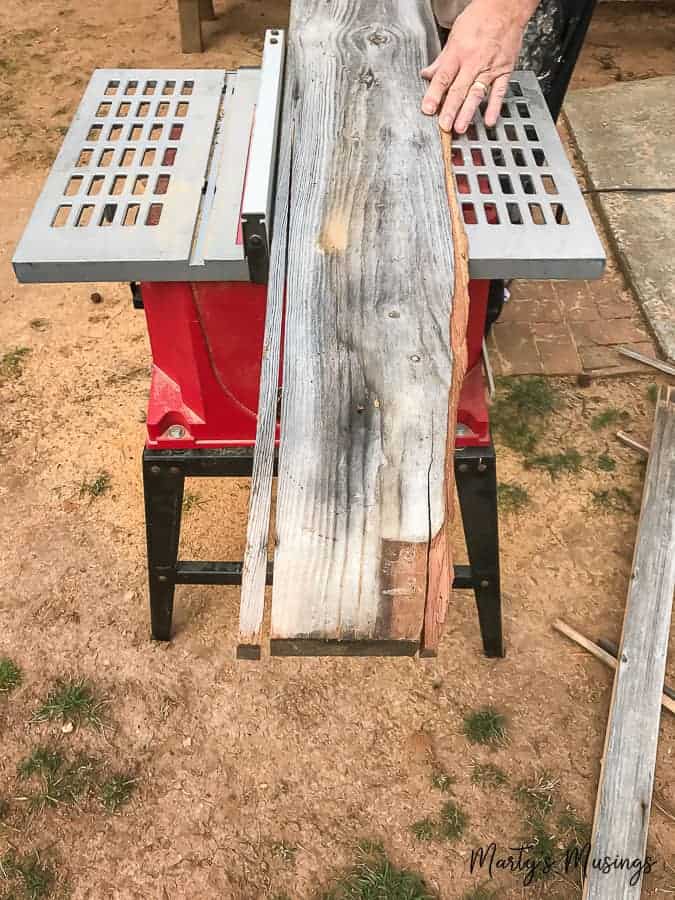 Learn how to build a sliding barn door (complete with a pet door!) with this step by step tutorial. #barnwood #DIY #barndoor #repurposed #rustic #fixerupper #martysmusings