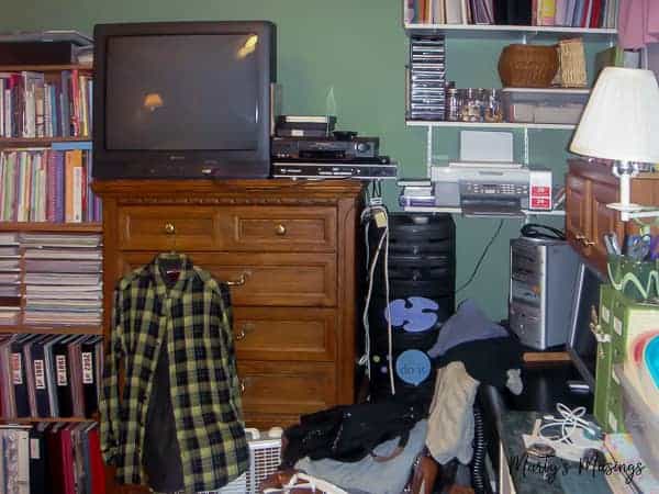 A desk with a laptop computer sitting on top of a book shelf