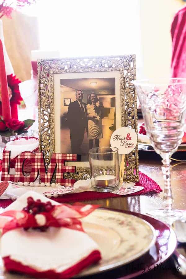 A table with a cake on a plate, with Valentine's Day and decoration