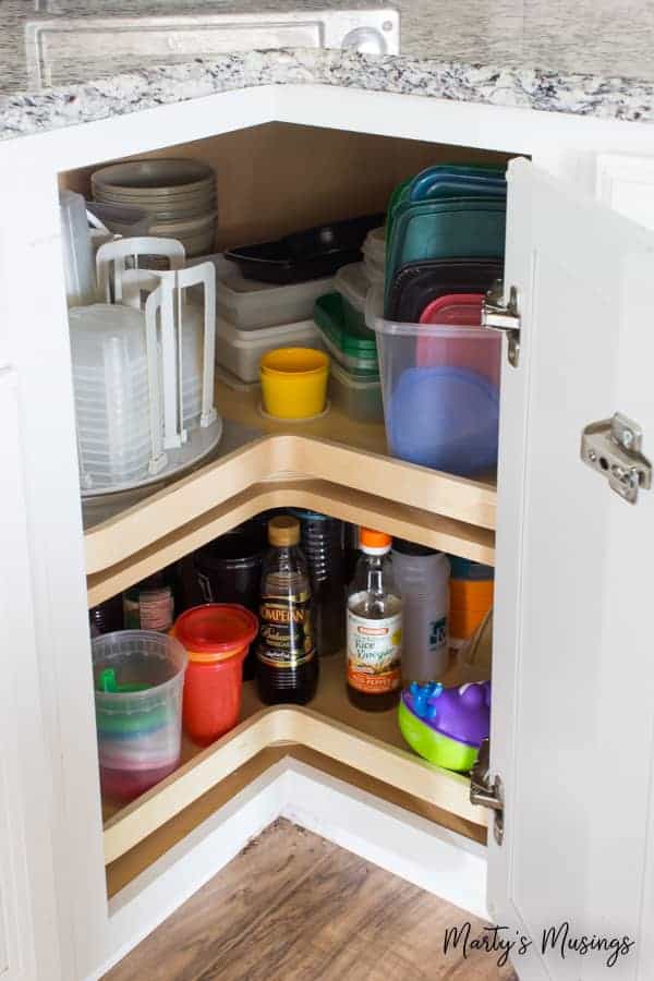 A bottle next to a refrigerator