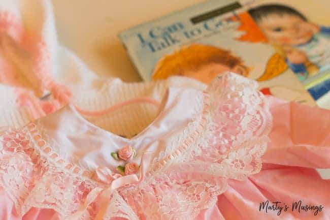 Baby dress with lace and book