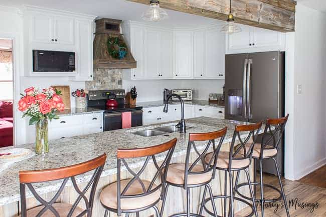 A kitchen with a stove top oven sitting in a chair