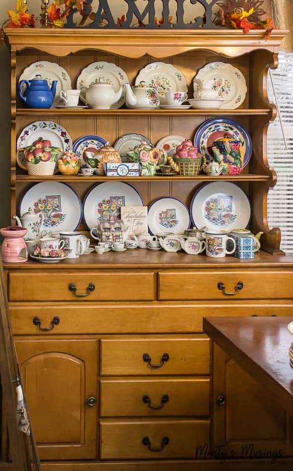 Kitchen hutch filled with plates and tea sets
