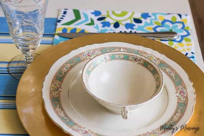 A china cup sitting on a vintage plate