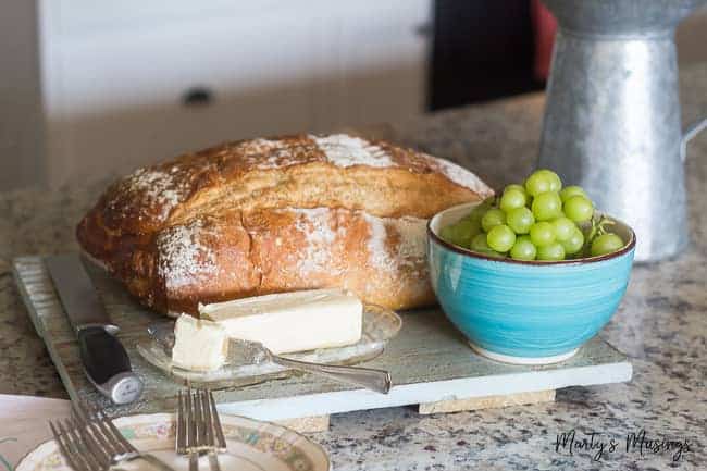 Homemade bread and grapes and on granite countertop