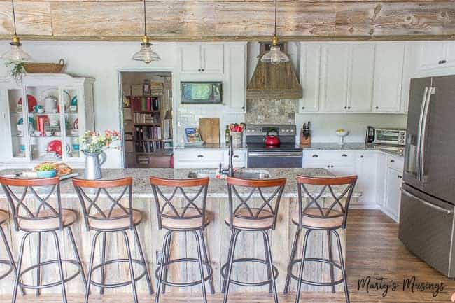 Ranch style kitchen with wall taken down and large island with chairs