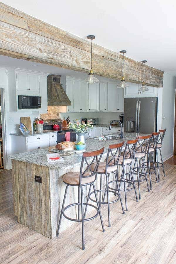 A kitchen area with wooden wheels in a room